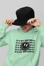 Mint green hooded sweatshirt with kangaroo pocket and birthday logo graphic print