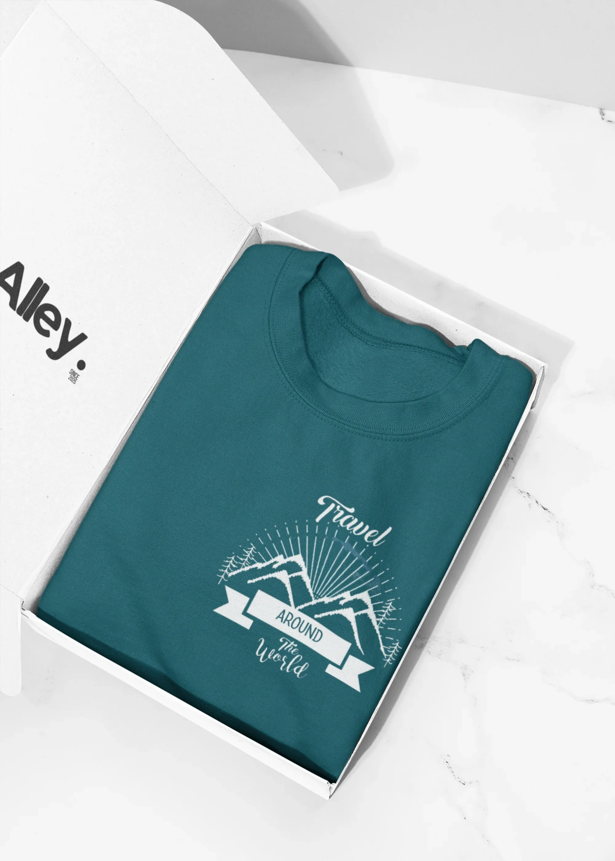 Teal crewneck sweatshirt, folded, with travel-themed chest logo graphic