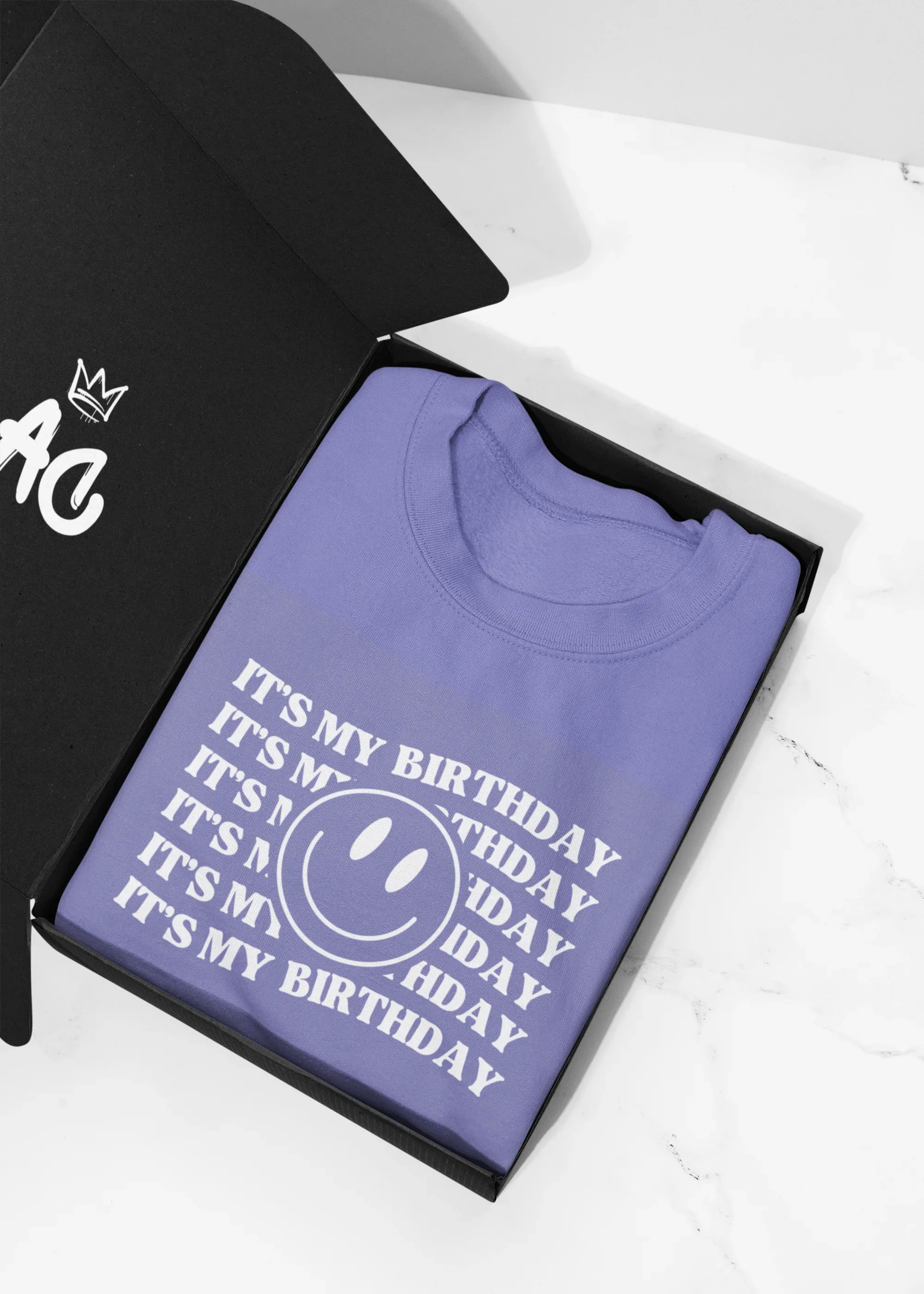 Purple crew hooded sweatshirt folded flat, showing birthday logo graphic print