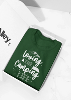 Forest green crewneck sweatshirt in box with white "Loving the Camping Life" graphic