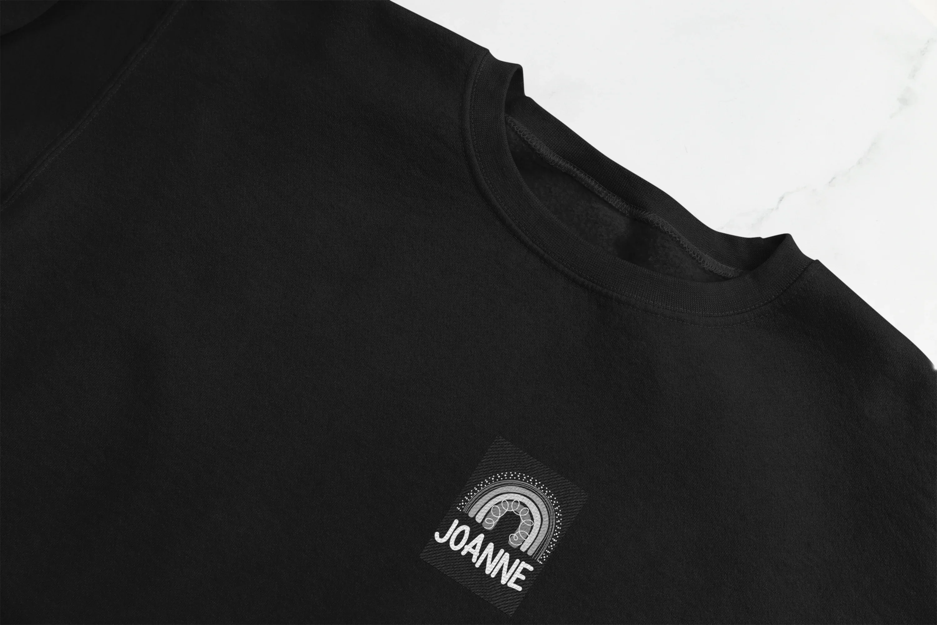 Black sweatshirt front with square JOANNE logo print