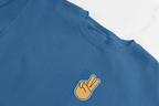 Royal blue sweatshirt detail: crew neck and embroidered peace hand on chest.