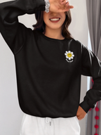 Black unisex sweatshirt with embroidered flower patch on chest
