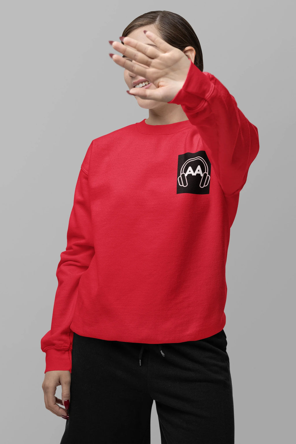 Red unisex sweatshirt with embroidered headphone logo on chest