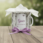 White mug with purple butterfly motif, bow ribbon, and name Grace with birth date text