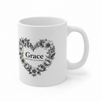 White ceramic mug with floral heart wreath and “Grace” on front