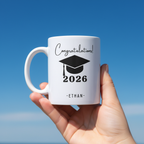 White ceramic graduation mug with 'Congratulations!' 2026 and ETHAN name text