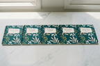 Row of A5 spiral notebooks with teal botanical covers and beige title labels.