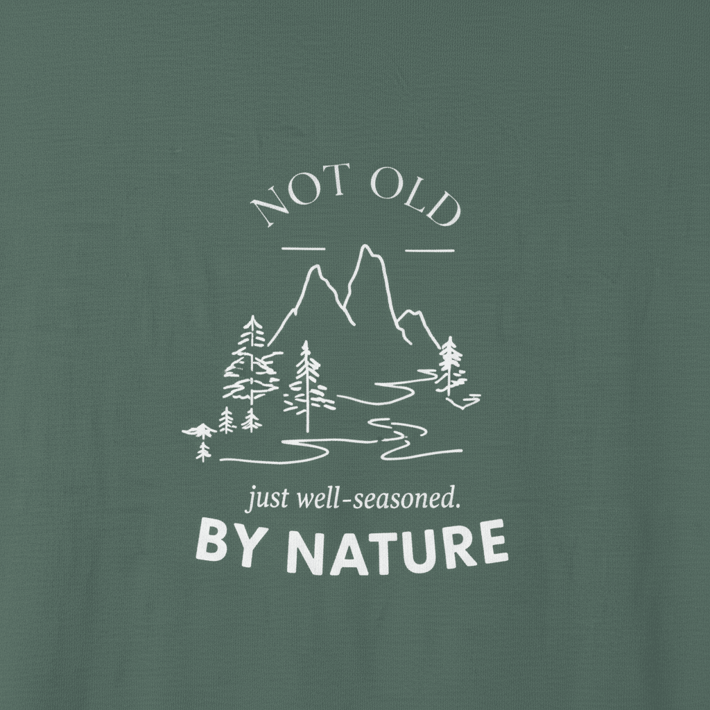 Dark green T-shirt with large centered mountain, trees, and 'BY NATURE' print