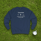 Navy crewneck sweatshirt with name “Charlotte” and coffee, trees, mountains graphic, front view.