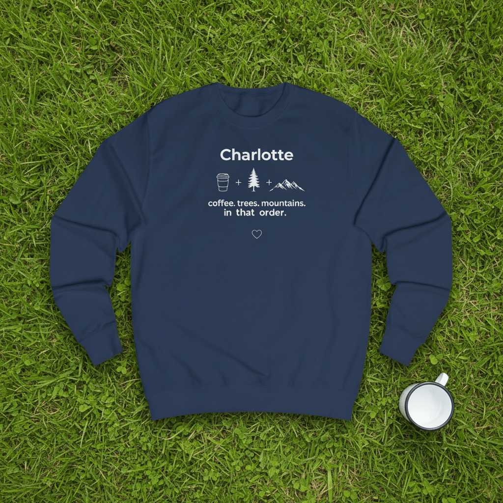 Navy crewneck sweatshirt with name “Charlotte” and coffee, trees, mountains graphic, front view.