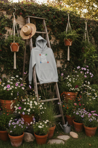 Light grey pullover hoodie hanging with star “Stay Trippy Little Hippie” graphic