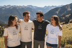 White T-shirts with 'BY NATURE' mountain graphic worn by group outdoors