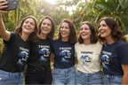 Group wearing Tropic Like It's Hot T-shirts in black, navy, and cream with blue palm chair graphic