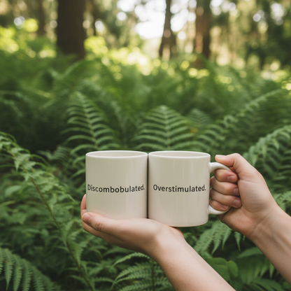 Hands holding mug outdoors with plants