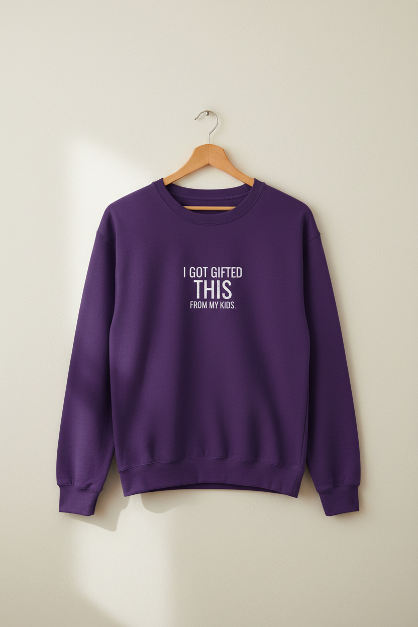 Purple crewneck sweatshirt on hanger with small chest text 'I GOT GIFTED THIS' 'FROM MY KIDS'