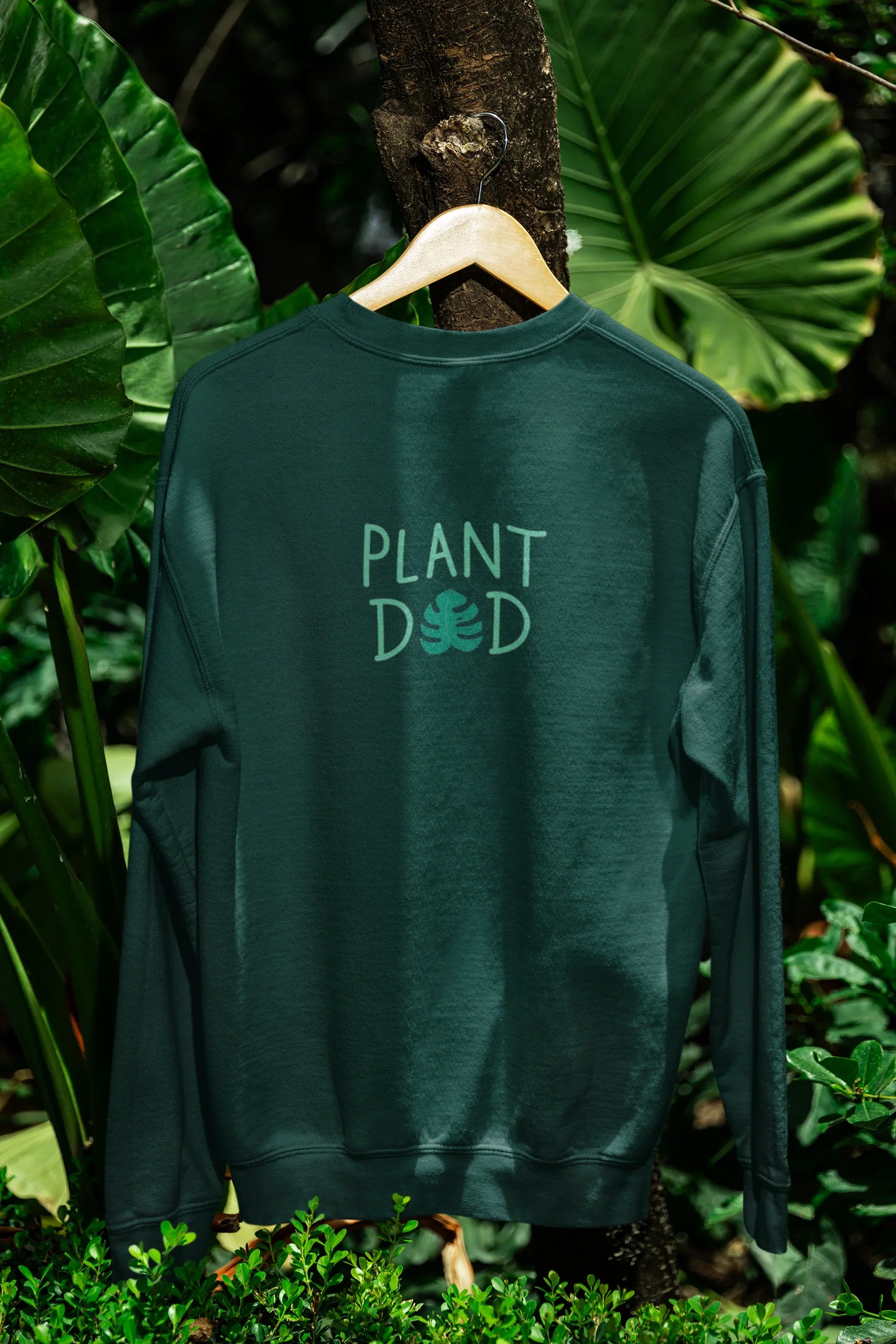 Bottle green crewneck sweatshirt with Plant Dad graphic on the front, long sleeves