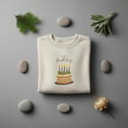 Cream birthday cake sweatshirt with front "Happy birthday" and lit candle cake graphic, crew neck.