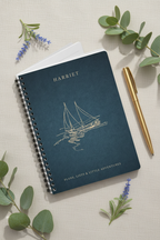Dark teal A5 spiral notebook with sailboat cover art and personalized name