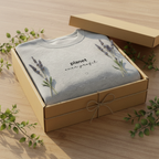 Heather gray crewneck sweatshirt in a gift box, chest print reads 'planet over profit'