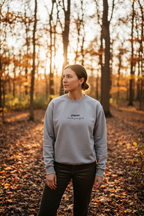 Heather gray crewneck sweatshirt with 'planet over profit' logo on the chest