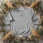 Heather gray crewneck sweatshirt close-up of chest text 'planet over profit' and heart