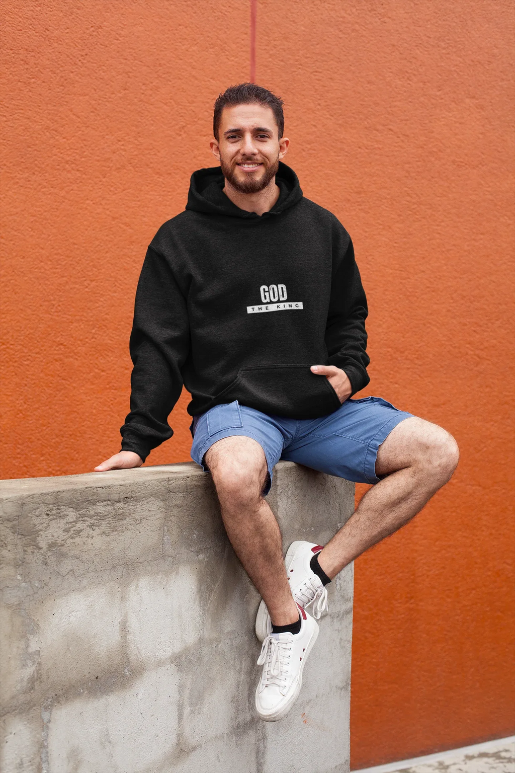 Black hooded sweatshirt with 'GOD THE KING' chest graphic and drawstring hood.