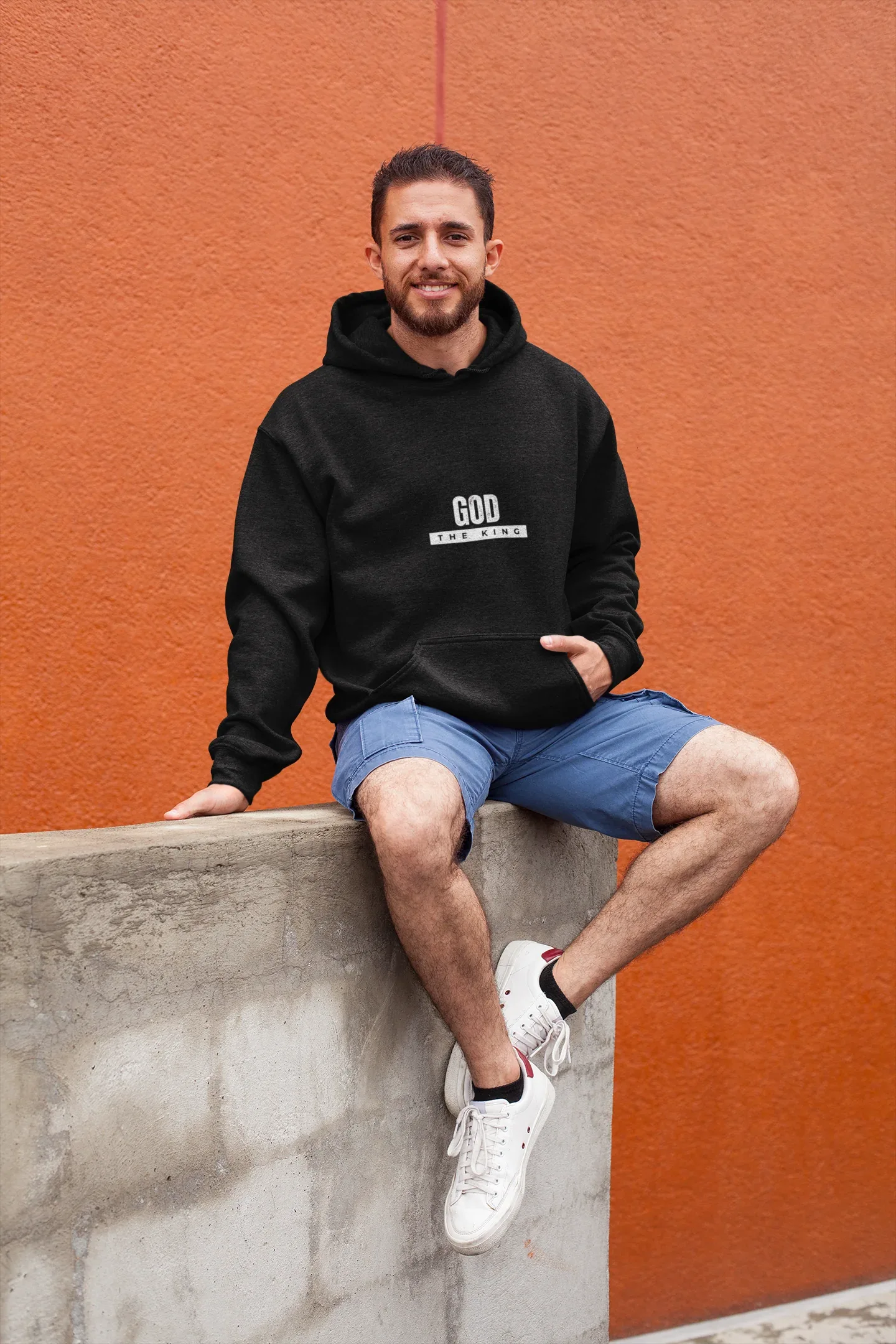 Black hooded sweatshirt with 'GOD THE KING' chest graphic and drawstring hood.