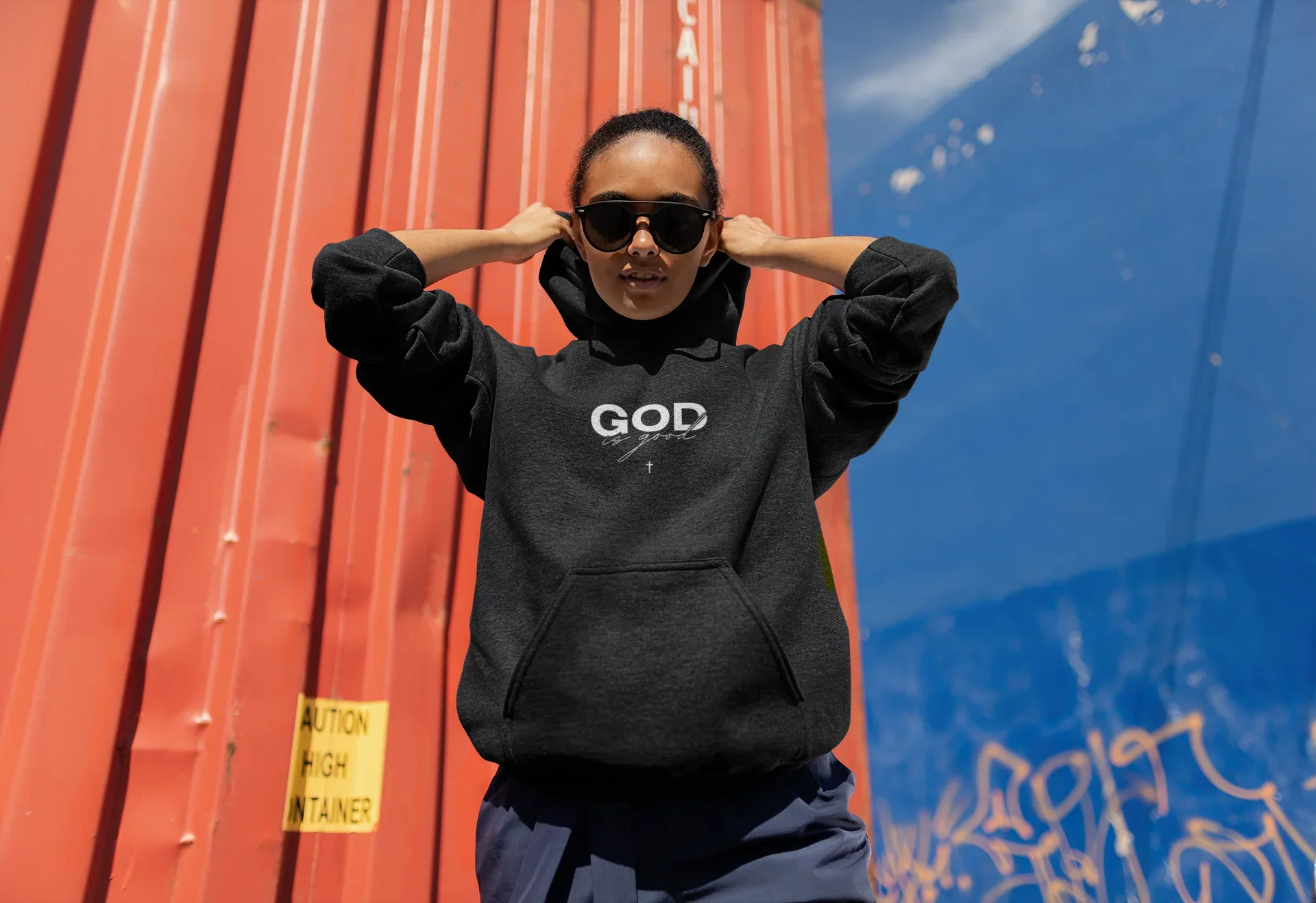 Black unisex hoodie with hood and long sleeves, 'GOD' logo on chest