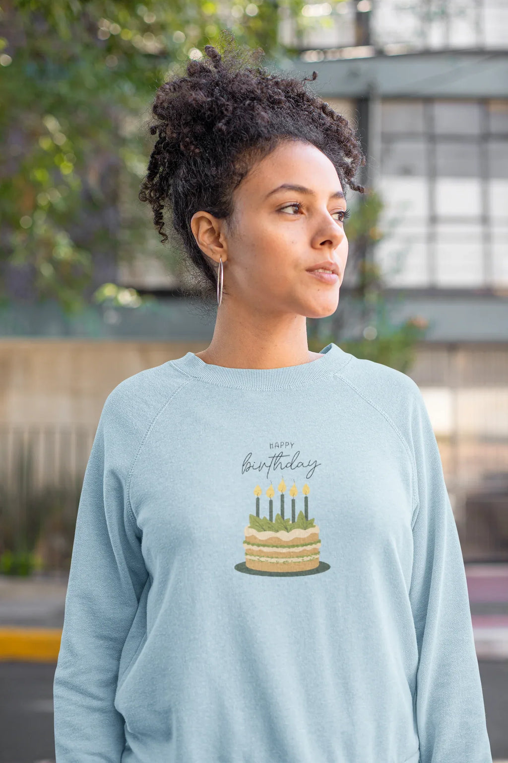 Light blue sweatshirt with birthday cake and candle print on the chest