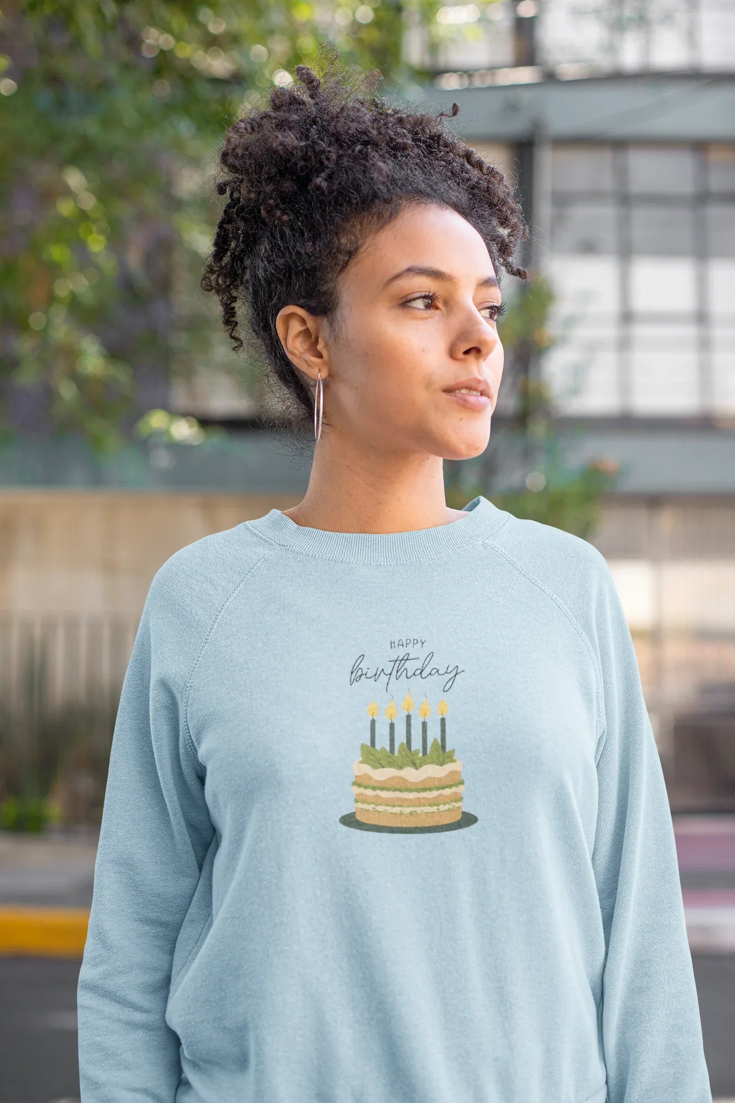 Light blue sweatshirt with birthday cake and candle print on the chest
