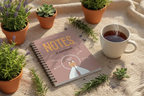 Spiral notebook on beige fabric with 'NOTES' cover and comfort zone graphic