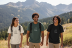 Nature graphic T-shirts in white, green, and black worn by hikers