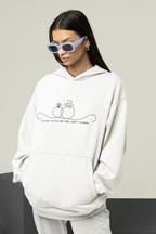 White unisex hoodie worn with hood and front pocket; line-art wedding rings graphic on chest.