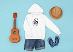 White kids hoodie with hood and front pocket, small floral letter and script name logo