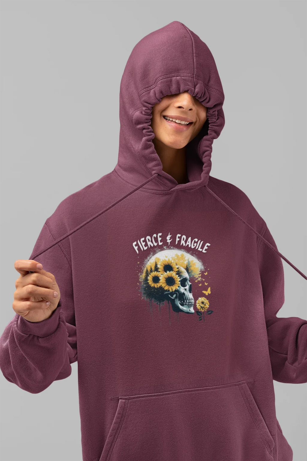 Maroon hooded sweatshirt with front graphic skull and flower design, drawstring hood and pouch pocket.