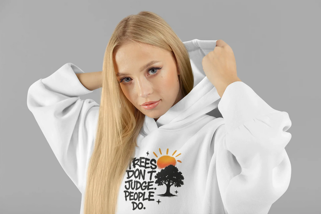 White hoodie worn by a model, featuring a chest graphic with tree and text