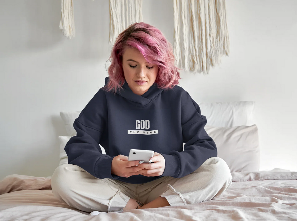 Navy hooded sweatshirt with 'GOD THE KING' chest graphic and cuffed sleeves.