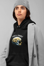 Black hooded sweatshirt with front graphic skull and flower design, drawstring hood and kangaroo pocket.