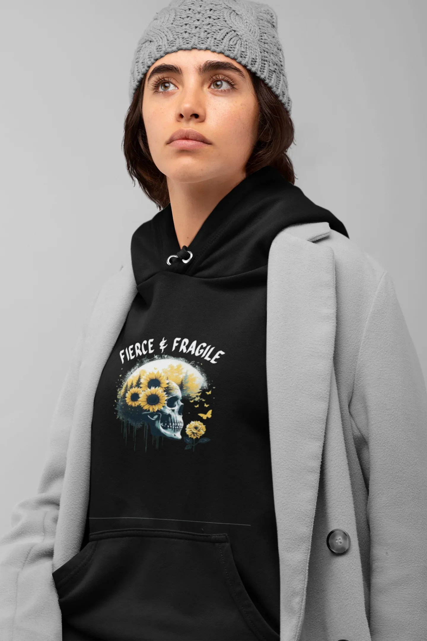 Black hooded sweatshirt with front graphic skull and flower design, drawstring hood and kangaroo pocket.