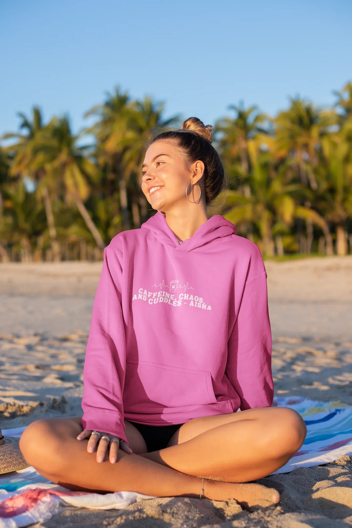 Pink hoodie sweatshirt with kangaroo pocket and 'Caffeine, Chaos, and Cuddles' chest text