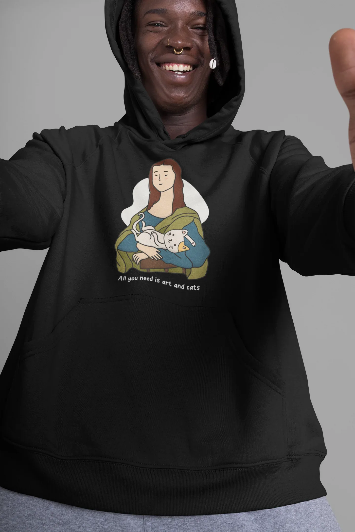 Black pullover hoodie with hood and front pocket, cat-and-art graphic