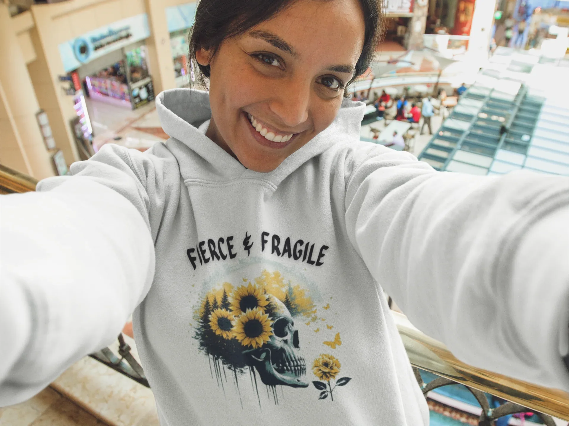 Light gray hooded sweatshirt with sunflower skull graphic and Fierce & Fragile text