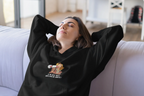Black hooded sweatshirt worn by model with woman megaphone graphic and front pocket