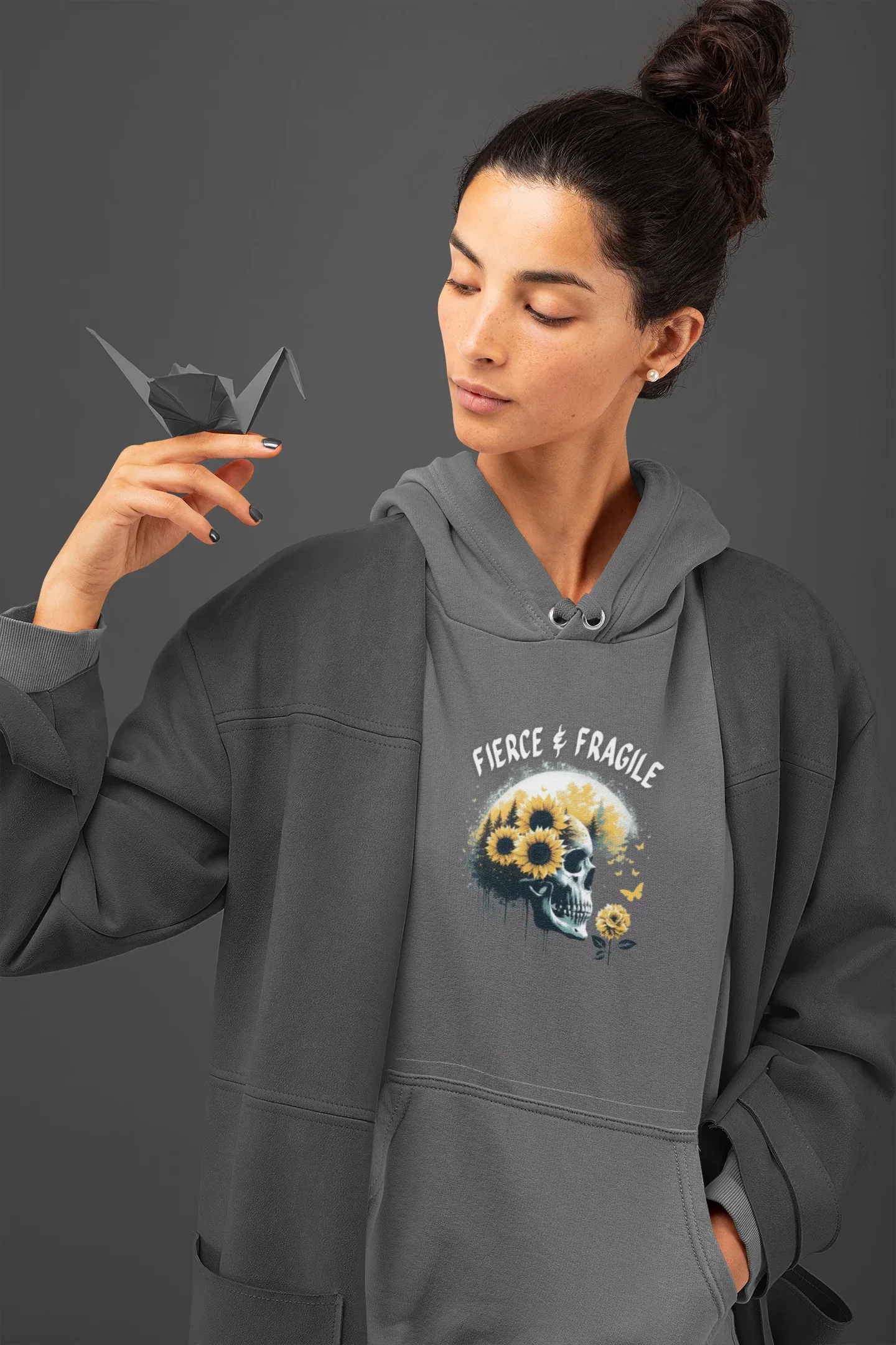Charcoal gray hooded sweatshirt with front graphic skull and flower design, drawstring hood and pouch.