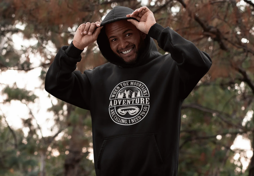 Black pullover hoodie with hood up and circular mountain “Adventure” logo on front.