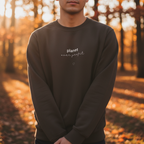 Black crewneck sweatshirt with centered planet logo text and small heart