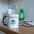 Two-tone ceramic mug with printed family quote, hearts and house icons