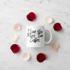 White ceramic coffee mug with 'I Love You More Than Coffee.' printed in black and hearts around