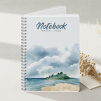 Sadie's personalised coastal watercolour A5 notebook standing upright on a pale linen surface with dried flowers and a folded cream card in a premium studio product photo